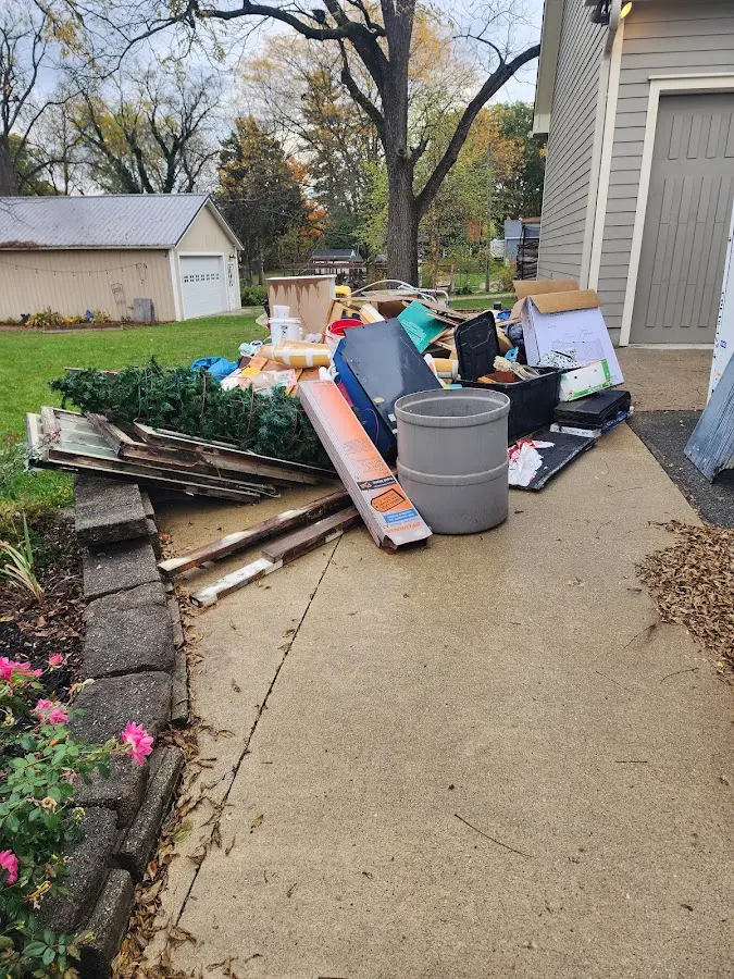 Dumpster being loaded with debris for Estate Cleanout Dumpster Rental in Cape Elizabeth